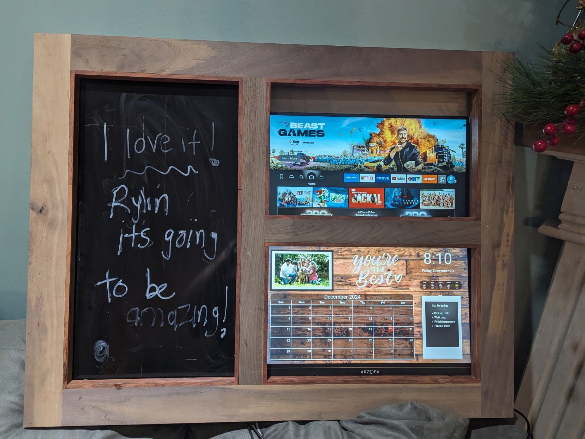 Custom-built walnut command centre with a chalkboard panel and two built-in screens